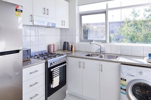 Full size family kitchen with cooking essentials