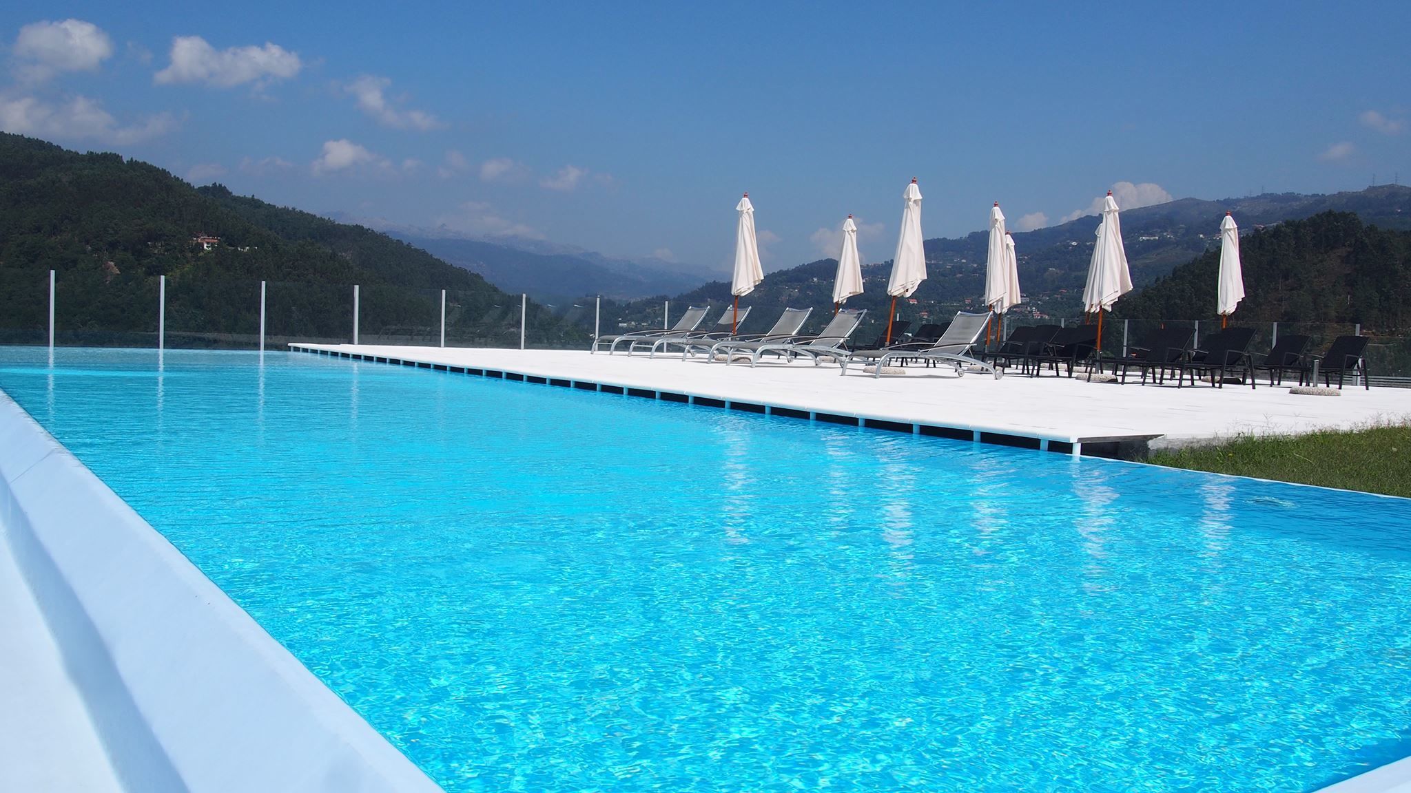 outdoor pool, open 10:00 am to 8:00 pm, pool umbrellas, pool loungers