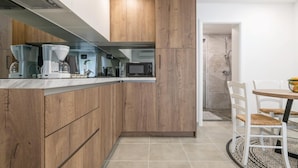 A modern kitchen with wooden cabinetry, a built-in microwave, and a coffee maker. - Awesome apartment in Fazana with WiFi (Fazana)