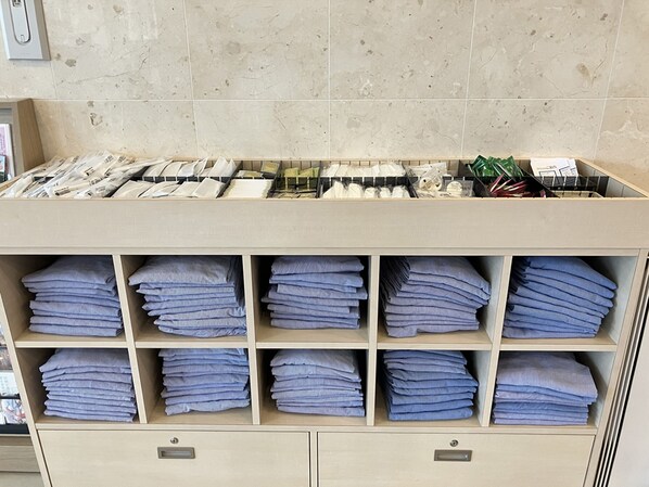 A neatly organized storage unit with multiple shelves holding folded towels and neatly arranged linens. - Toyoko Inn Sodegaura Station Kita (Sodegaura)