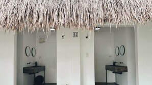 A modern bathroom with two sinks, mirrors, and potted plants. - Pig Dive Hostel (Moalboal)
