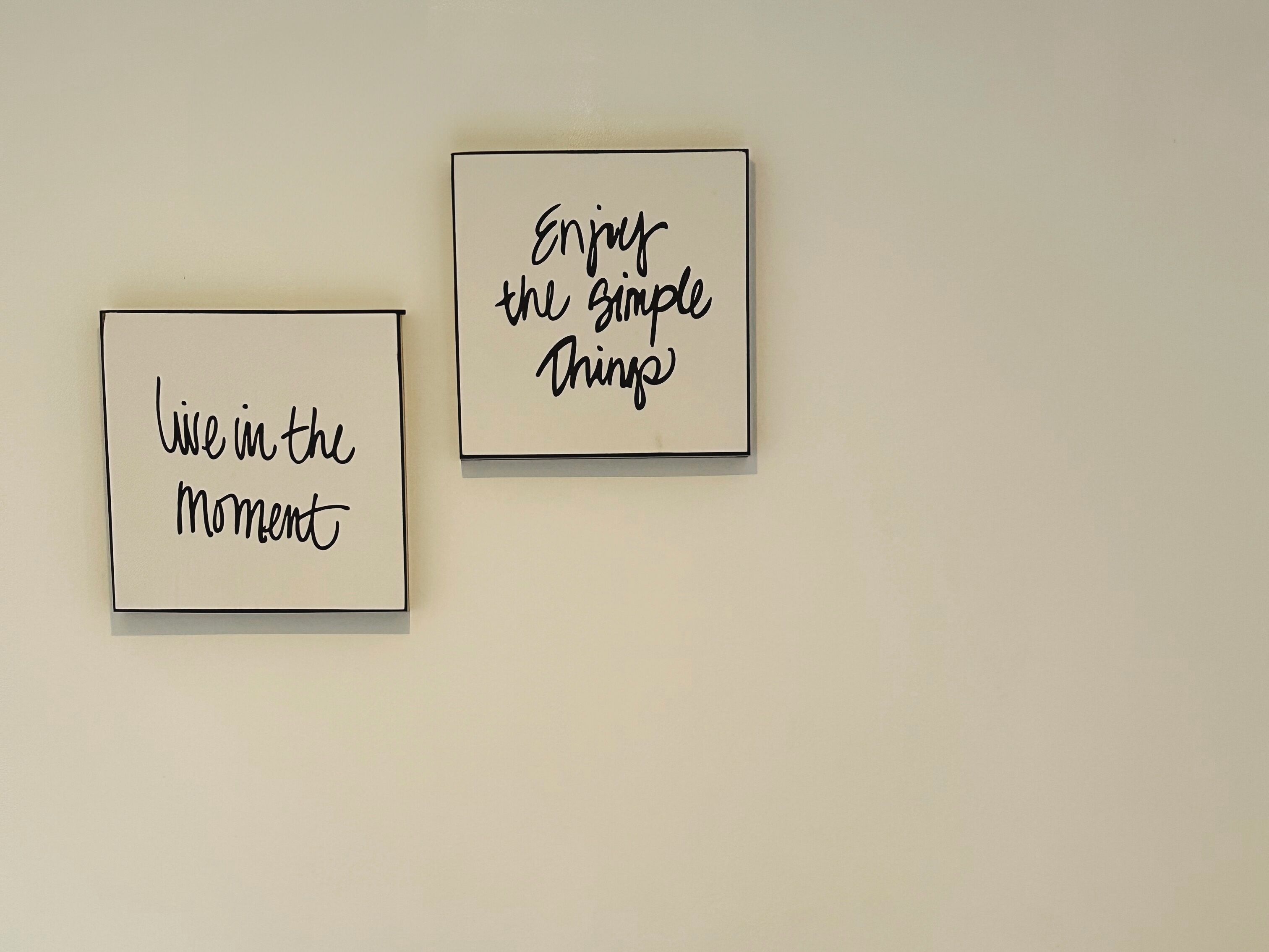 Two framed inspirational quotes on a wall.