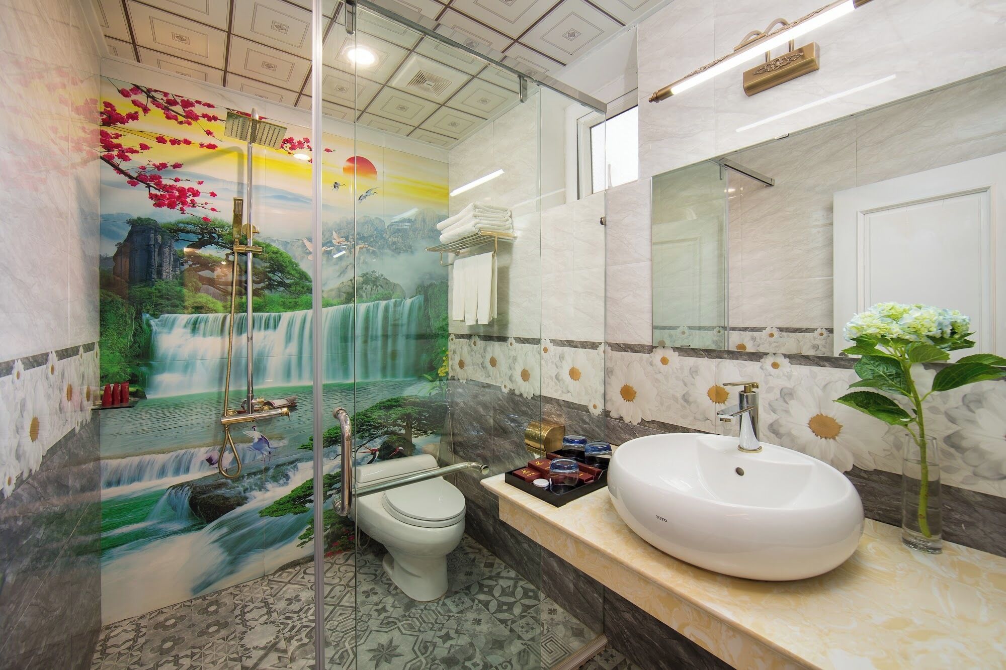 A modern bathroom with a large sink, a toilet, and a shower area.