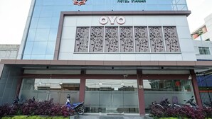 A modern building with the name "EDOTEL AMANAH HOTEL" and "OYO" branding.