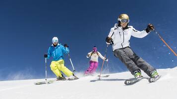 Three skiers on a snowy slope.