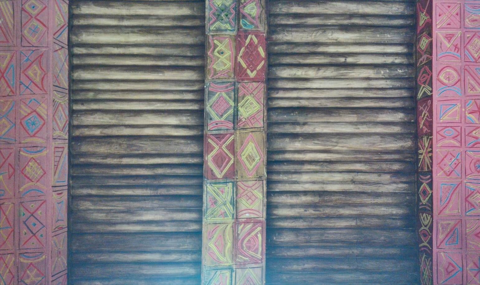 A set of metal shutters with colorful geometric patterns on the sides.