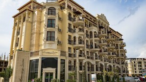 A multi-story hotel with balconies, large windows, and a central entrance. - Menada Harmony Suites X Apartment (Sveti Vlas)