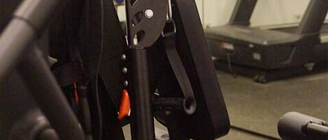 A gym equipment setup with a bench and a weight machine.