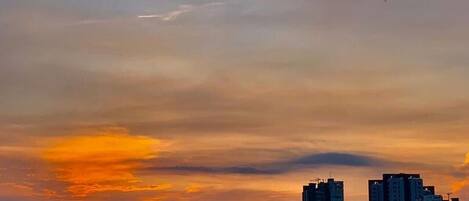 A cityscape with high-rise buildings during sunset.