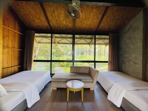 A room with two beds, a sofa, and a small table.