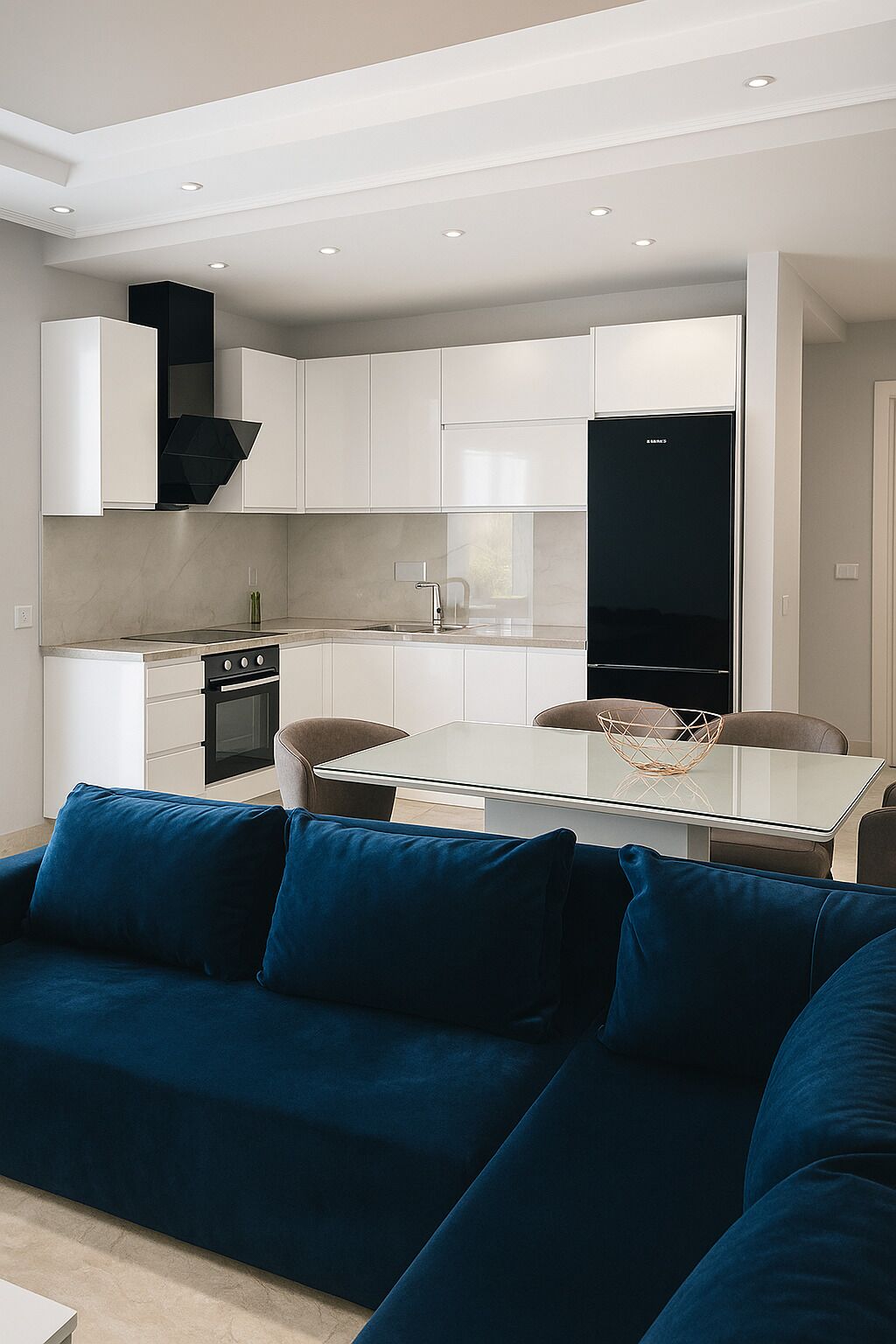 A modern kitchen with white cabinetry, a black range hood, and a glass dining table.
