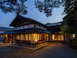 A traditional Japanese building with a covered entrance and multiple windows.