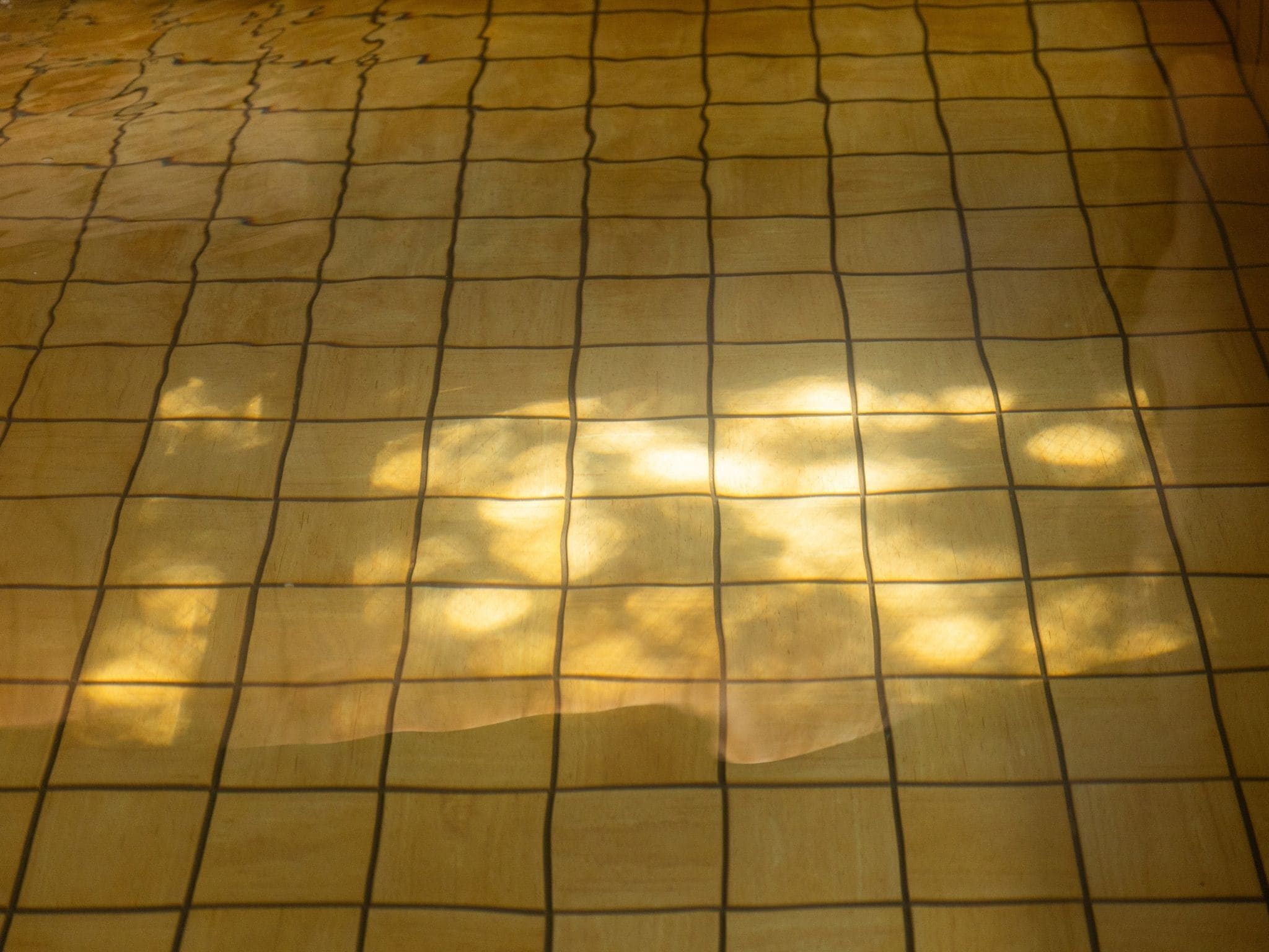 A tiled floor with a grid pattern.