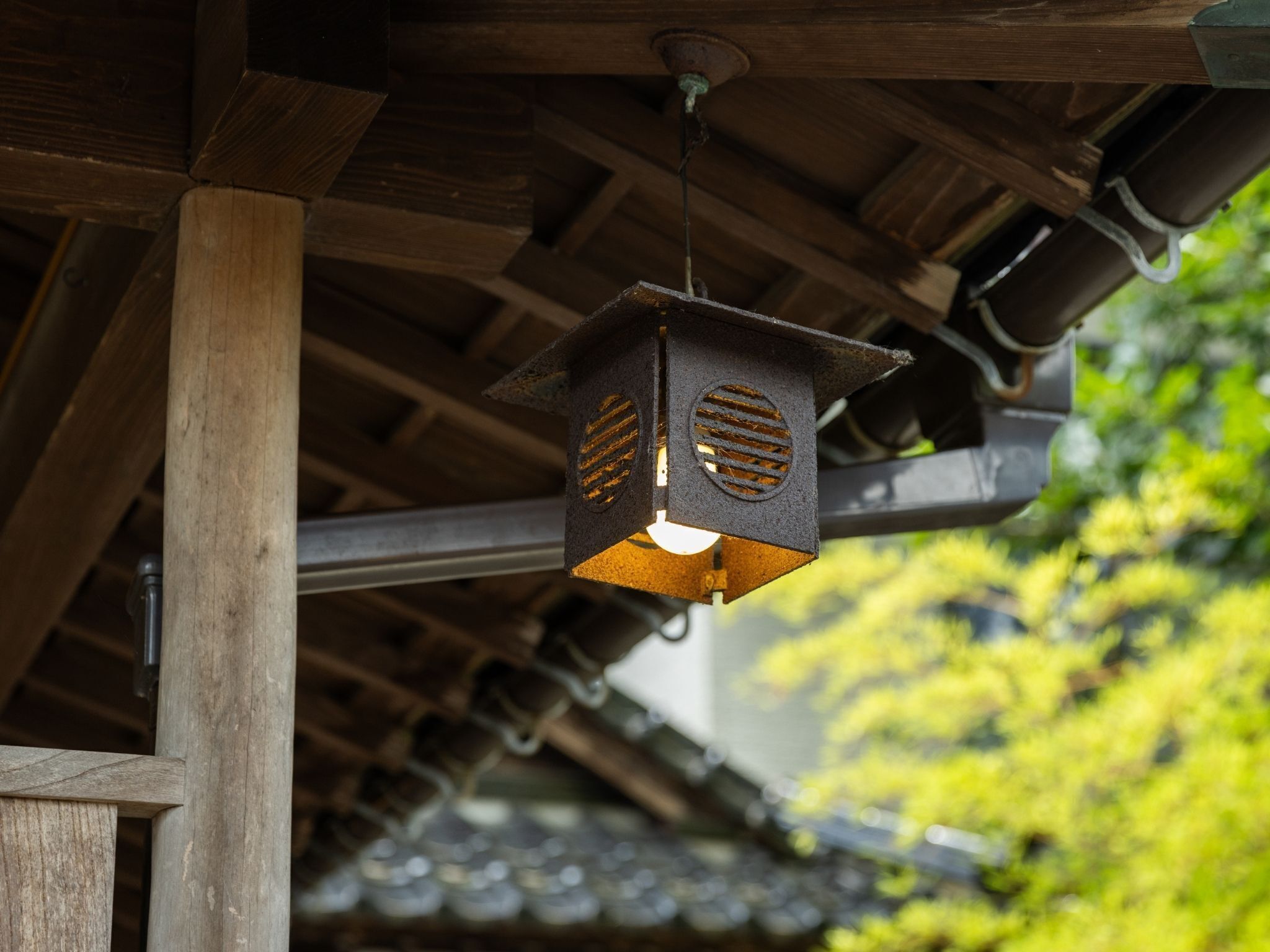 A traditional wooden structure with a hanging lantern.