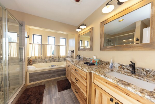 A modern bathroom with a glass shower enclosure, a bathtub, a vanity with a sink, and a large mirror. - Keystone Large Family Home - Amazing Views, Rustic Charm - Hot Tub, Game Room (Dillon)