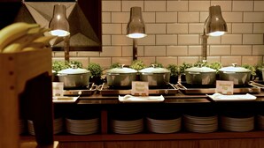 A buffet setup with multiple food stations, each labeled with different dishes like 'Baked Beans' and 'Scrambled Eggs'. - Holiday Inn Express Barrow-in-Furness by IHG (Barrow-in-Furness)