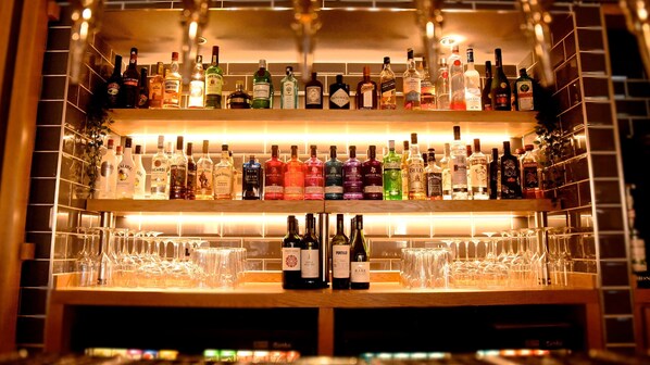 A bar with multiple shelves of liquor bottles and glasses. - Holiday Inn Express Barrow-in-Furness by IHG (Barrow-in-Furness)