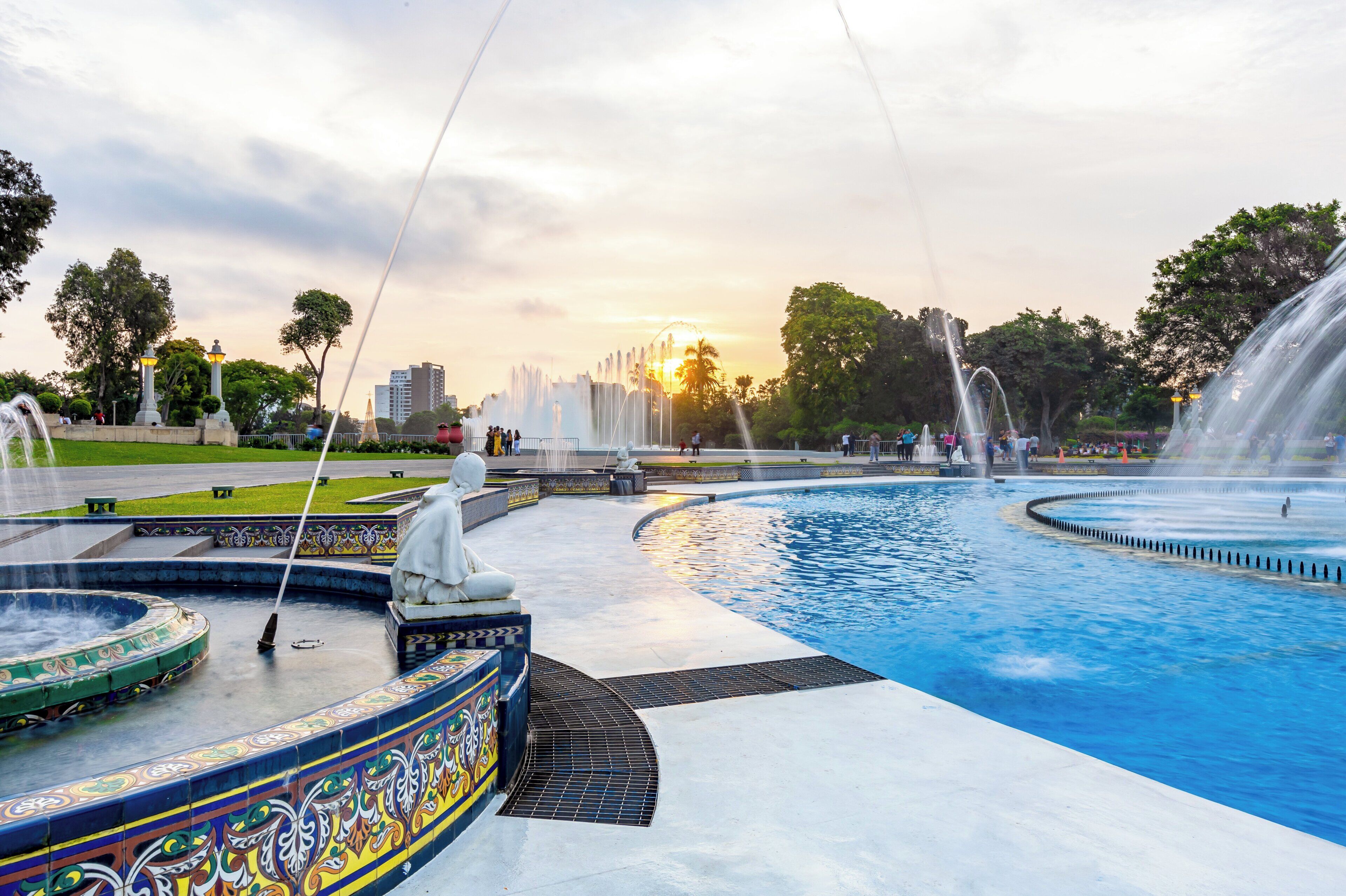 A fountain with multiple water jets, surrounded by a tiled pool with decorative patterns.
