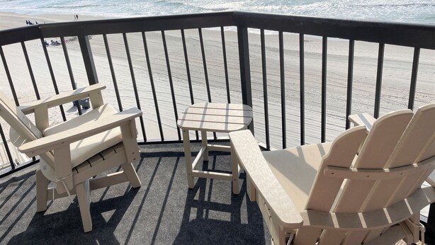 A balcony with a view of the beach and ocean. - Oceanfront condo w/direct beach access & 180 degree views from your private deck (Garden City Beach)