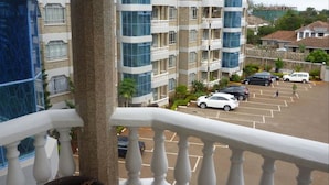 A multi-story building with balconies and a parking lot. - Sheema Villas (Nairobi)