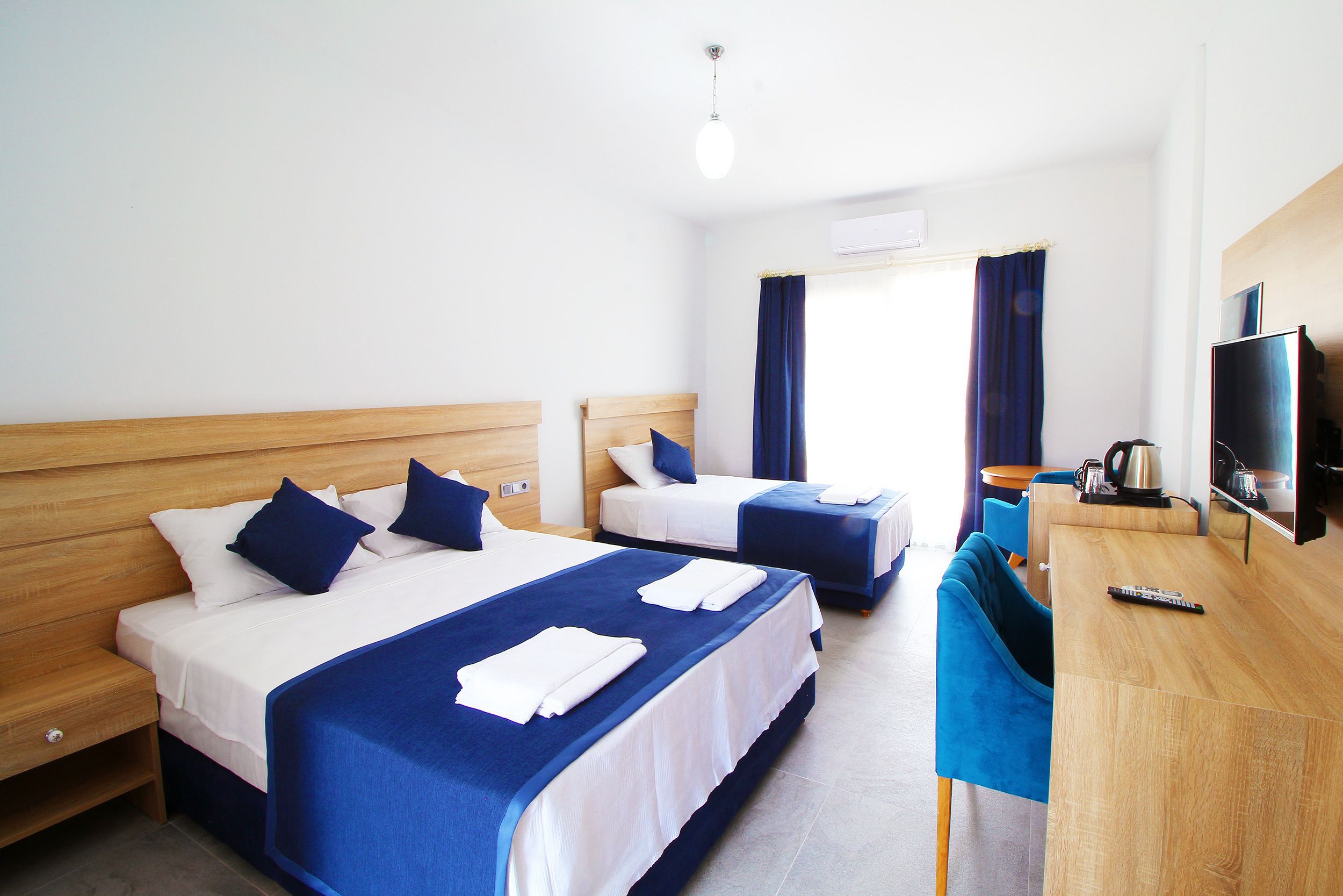 Standard Triple Room | In-room safe, desk, laptop workspace, blackout curtains