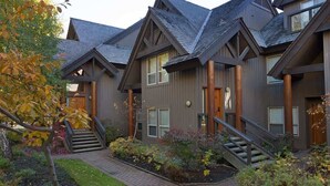 A multi-story building with a symmetrical facade, wooden beams, and a central staircase.