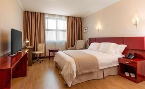 Relax in comfort with a large bed, desk, and flat-screen TV.