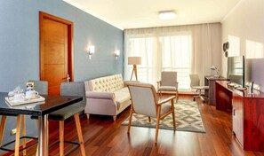 Relax in this stylish room with a sofa set, dining area, flat-screen TV, and desk.
