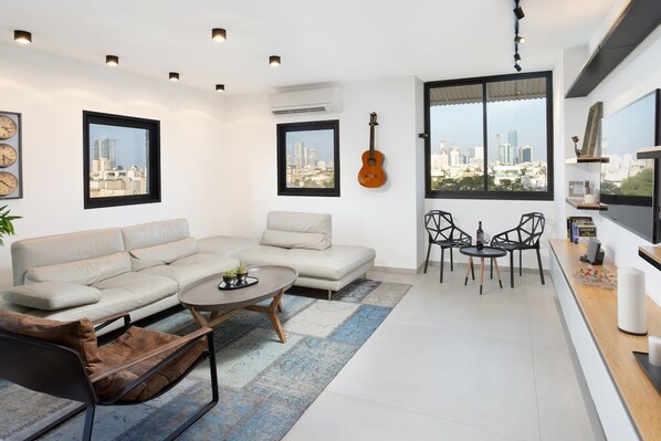 Luxury Apartment, 3 Bedrooms | Living area | Smart TV - Chic 3BR in Smolenskin by HolyGuest (Tel Aviv)