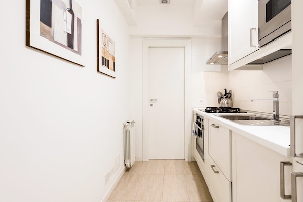 Modern kitchen with oven, microwave, double sink, and gas stove.