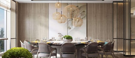 A modern dining room with a round table, multiple chairs, and a large wall art piece.