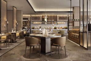 Un comedor moderno con una isla central, diversas opciones de asientos y una cocina al fondo.