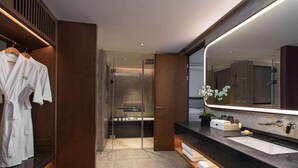 A modern bathroom with a large mirror, dark wood cabinetry, a glass shower enclosure, and a wooden bench. - Wingate by Wyndham Hainan Chengmai (Chengmai)