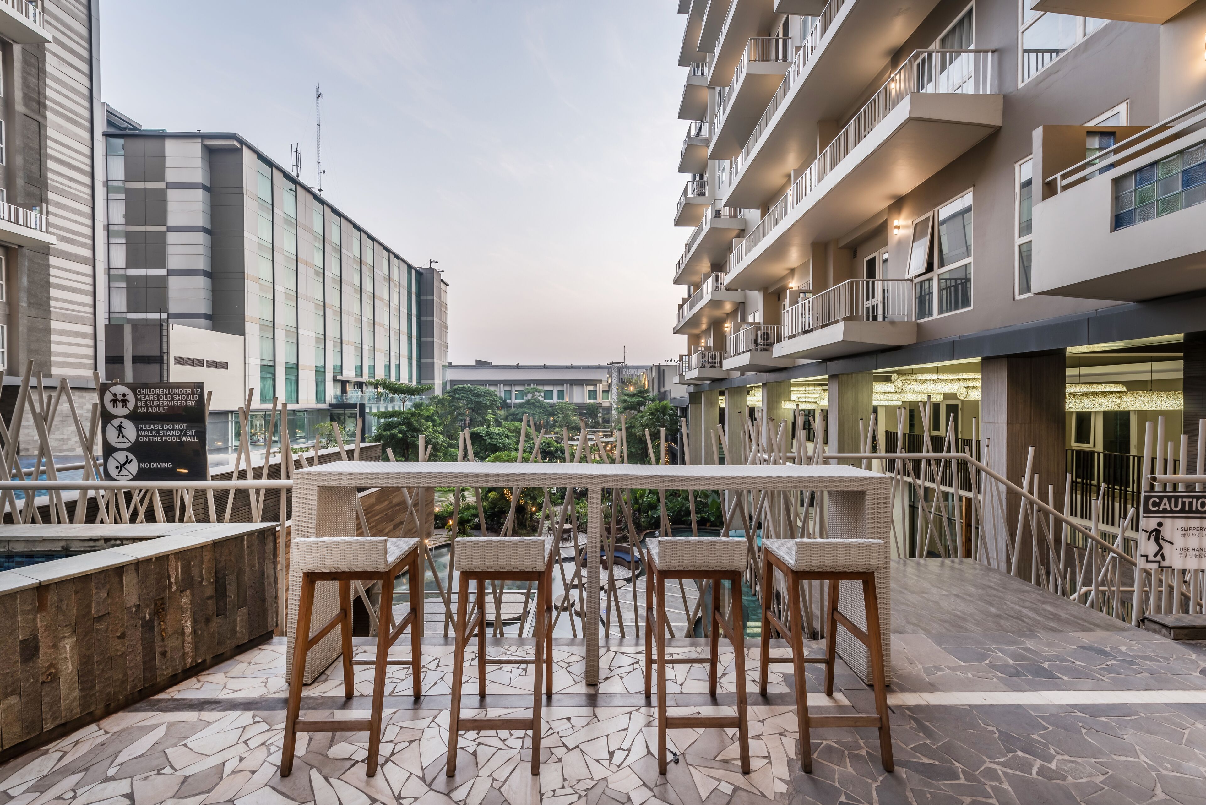 A rooftop terrace with outdoor seating and a view of the cityscape.