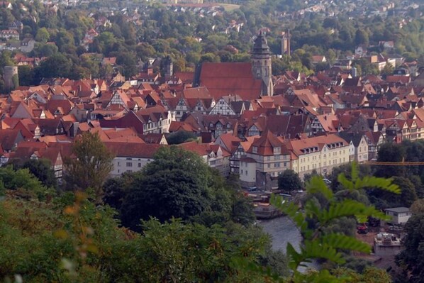 A town with traditional architecture, including half-timbered houses and a prominent tower. - Landgasthaus zur Brücke (Hann. Muenden)