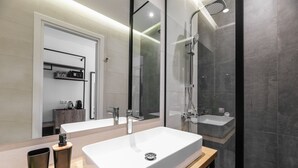 A modern bathroom with a large white sink, a shower, and a mirror. - Evapollo (Thessaloniki)