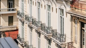 A multi-story building with balconies, a dome-shaped roof, and satellite dishes. - Evapollo (Thessaloniki)