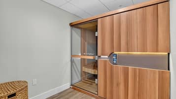 A room with a sliding wooden wardrobe, a glass door, and a woven basket.