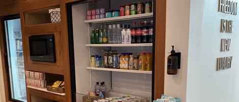 A store with shelves stocked with snacks, beverages, and kitchen appliances.