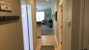 A hallway with a sign indicating Sunset Beach, NC coordinates. - 22C Sandpiper Bay (Sunset Beach)