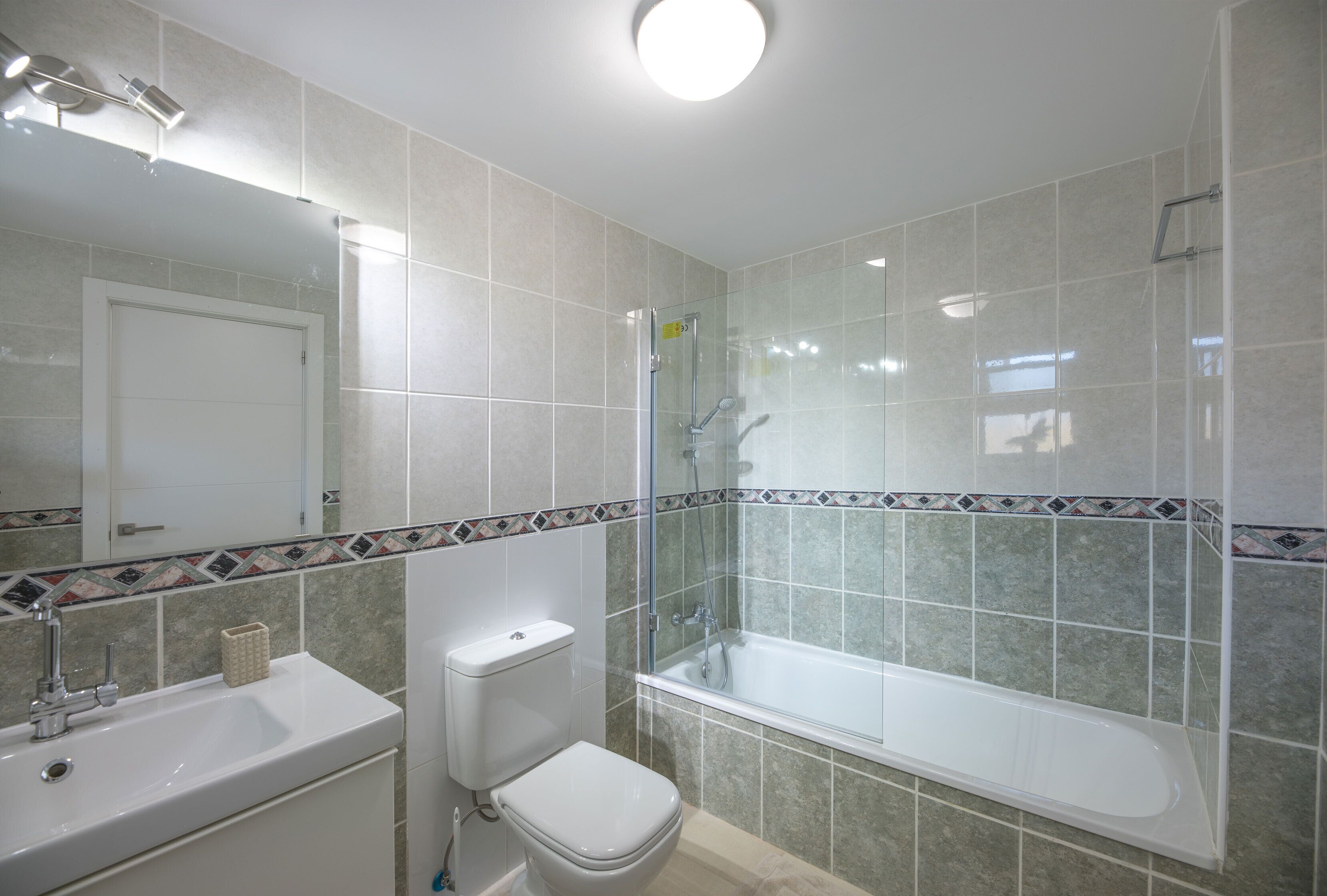 A bathroom with a sink, toilet, and bathtub.