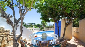 A patio with a table and chairs, a swimming pool, and a view of the surrounding area. - La Marina by Interhome (Benissa)