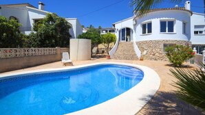 A swimming pool with a stone pathway leading to a white house with a stone facade and a curved roof. - La Marina by Interhome (Benissa)