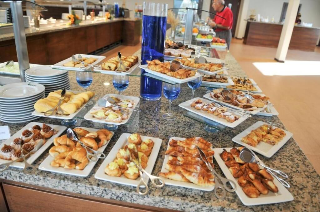 A buffet with various food items and utensils.