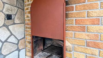 A stone and brick wall with a metal structure.
