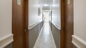 A hotel hallway with doors numbered 07 and 06, leading to rooms.