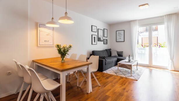 A modern living room with a dining area, a grey sofa, and a wooden dining table. - Apartment Apartment In Centre For 6 (Split)