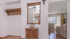 A room with a wooden cabinet, a mirror, and a wooden shelf. - Apartment Nansy (Omis)