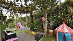 A children's play area with a slide, a tent, and a small table. - Apartment Visnja (Rijeka)