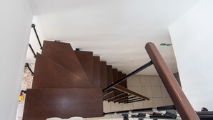 Una moderna scala con ringhiera in metallo e gradini marroni.